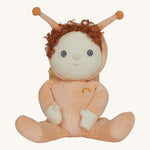 The Olli Ella Dinky Dinkum Doll - Scottie Snail - in a soft light orange onesie with curly red hair, a snail shell on his back, and antennae.