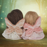 Olli Ella Fiona and Faye fairy dinky dinkum dolls sitting next to eachother and facing a fantasy background and showing the wing detail