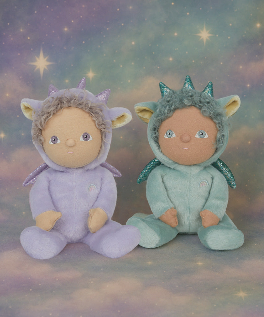 Olli Ella Dante the dragon dinky dinkum doll sitting next to duffy the dragon with a dreamy starry background