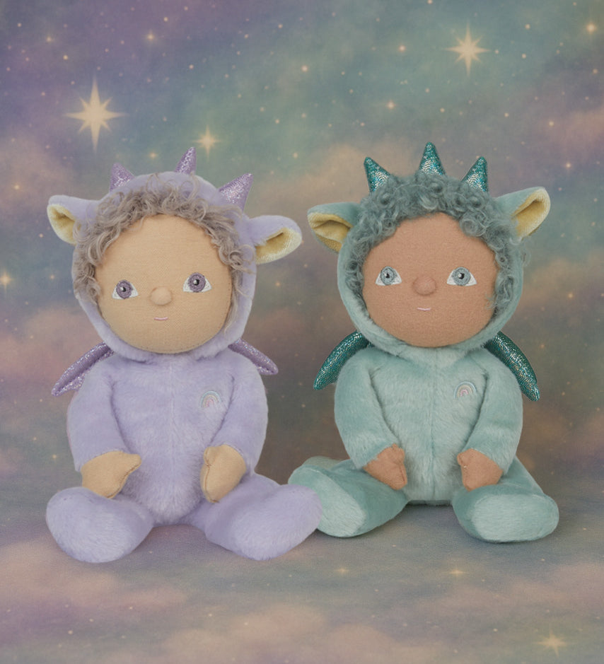 Olli Ella Dante the dragon dinky dinkum doll sitting next to duffy the dragon with a dreamy starry background