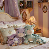 All Olli Ella dragon dolls standing on a bed in a fairytale inspired bedroom. These two dragons are available at Babipur.