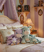All Olli Ella dragon dolls standing on a bed in a fairytale inspired bedroom. These two dragons are available at Babipur.
