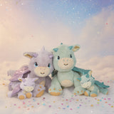 All Olli Ella dragon dolls in a group with a dreamy background and falling confetti. These two dragons are available at Babipur.