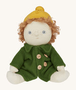 Charlie Chestnut is a Dress Me Dinky Doll by Olli Ella, complete with a removable cosy green fleece trench coat, yellow bobble beanie hat . Sat down, cream background.