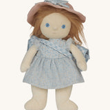 Penelope Petals Dress Me Dinky Dinkum Doll standing with her blue floral dress, pink hat, and gingham blanket bag from Olli Ella.