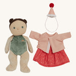 Olli Ella Dress Me Dinky - Sophie Sundae, a doll with brown hair and green eyes undressed showing her non removable green bodysuit, with her pink polka dot dress, light pink cardigan and a pink party hat to one side. Cream background.