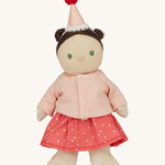 Olli Ella Dress Me Dinky - Sophie Sundae, a doll with brown hair and green eyes wearing a pink polka dot dress, light pink cardigan and a pink party hat. Cream background.