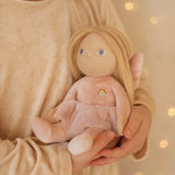 A child clutching the Olli Ella Fiona fairy dinky dinkum doll available at Babipur. 