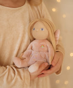 A child clutching the Olli Ella Fiona fairy dinky dinkum doll available at Babipur. 