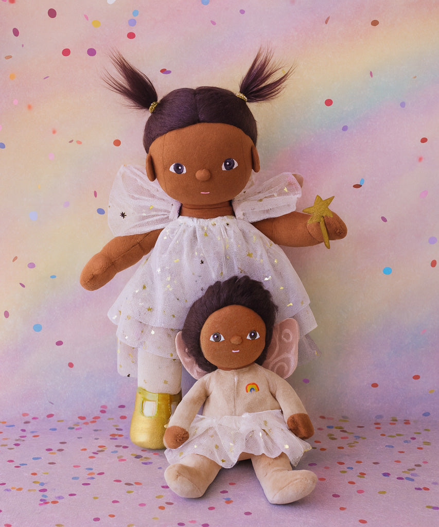 Olli Ella Freya dream dinkum doll sitting next to Faye dinky dinkum doll against a dreamy background with confetti on the floor