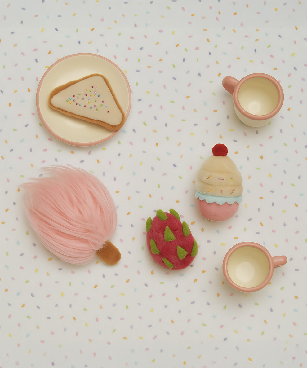 Olli Ella fairy food set on a dotted table cloth A set of 4 soft plush food items including a  cupcake, fairy bread, dragonfruit and candy floss