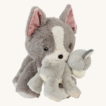 Gizmo the Olli Ella dinkum dog with a soft grey and white banjo the dinkum puppy in its mouth on a cream background