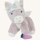 The Olli Ella Glimmer unicorn, which has light purple fur and a white mane with pastel coloured streaks, with a purple carrot at its feet