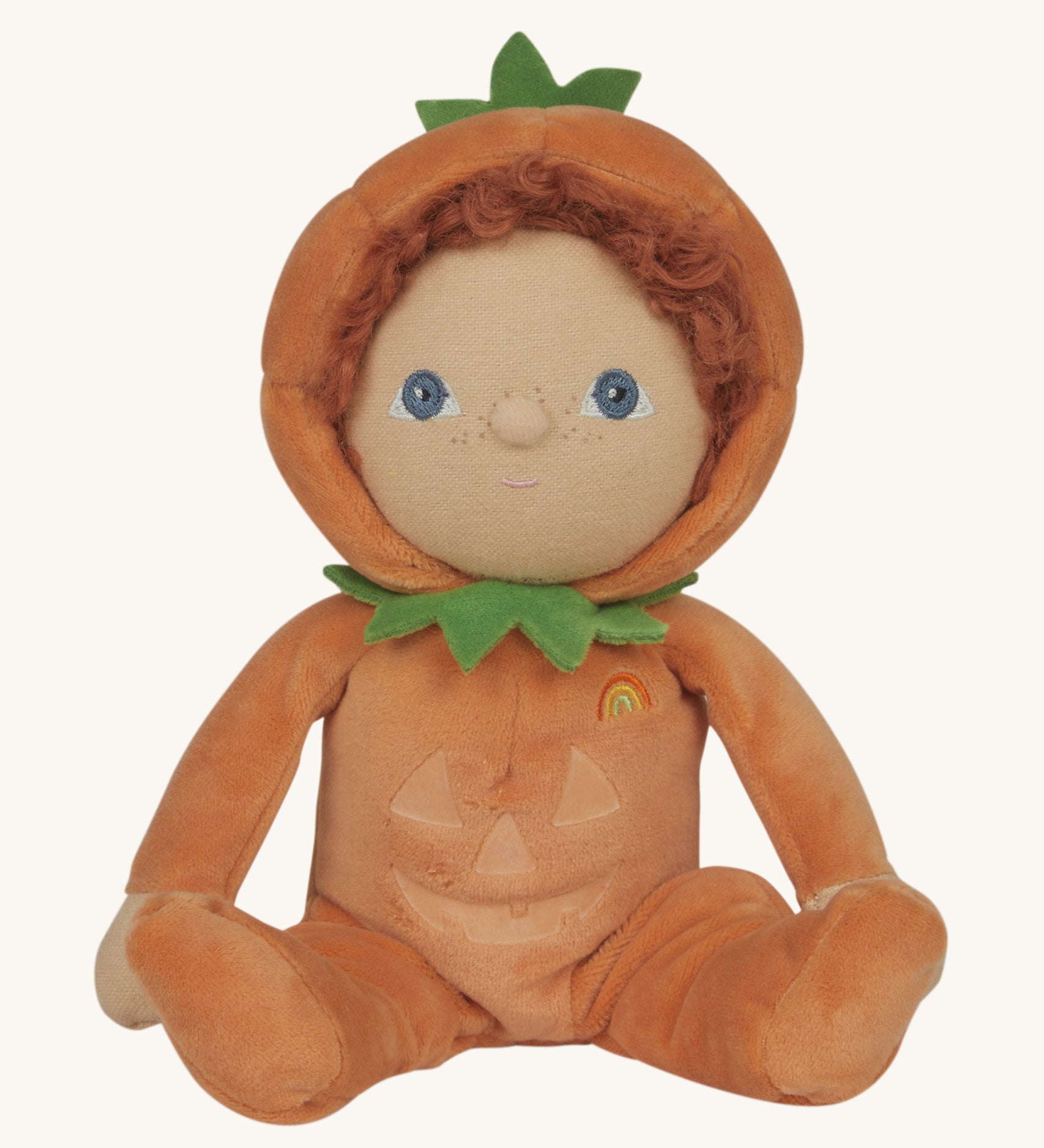 An Olli Ella Jack-O-Lantern pumpkin dinky dinkum doll. The soft doll has a glow in the dark face on it's belly and a small embroidered rainbow detail on it's chest. These soft toys are part of Olli Ella's Halloween collection available here at Babipur.