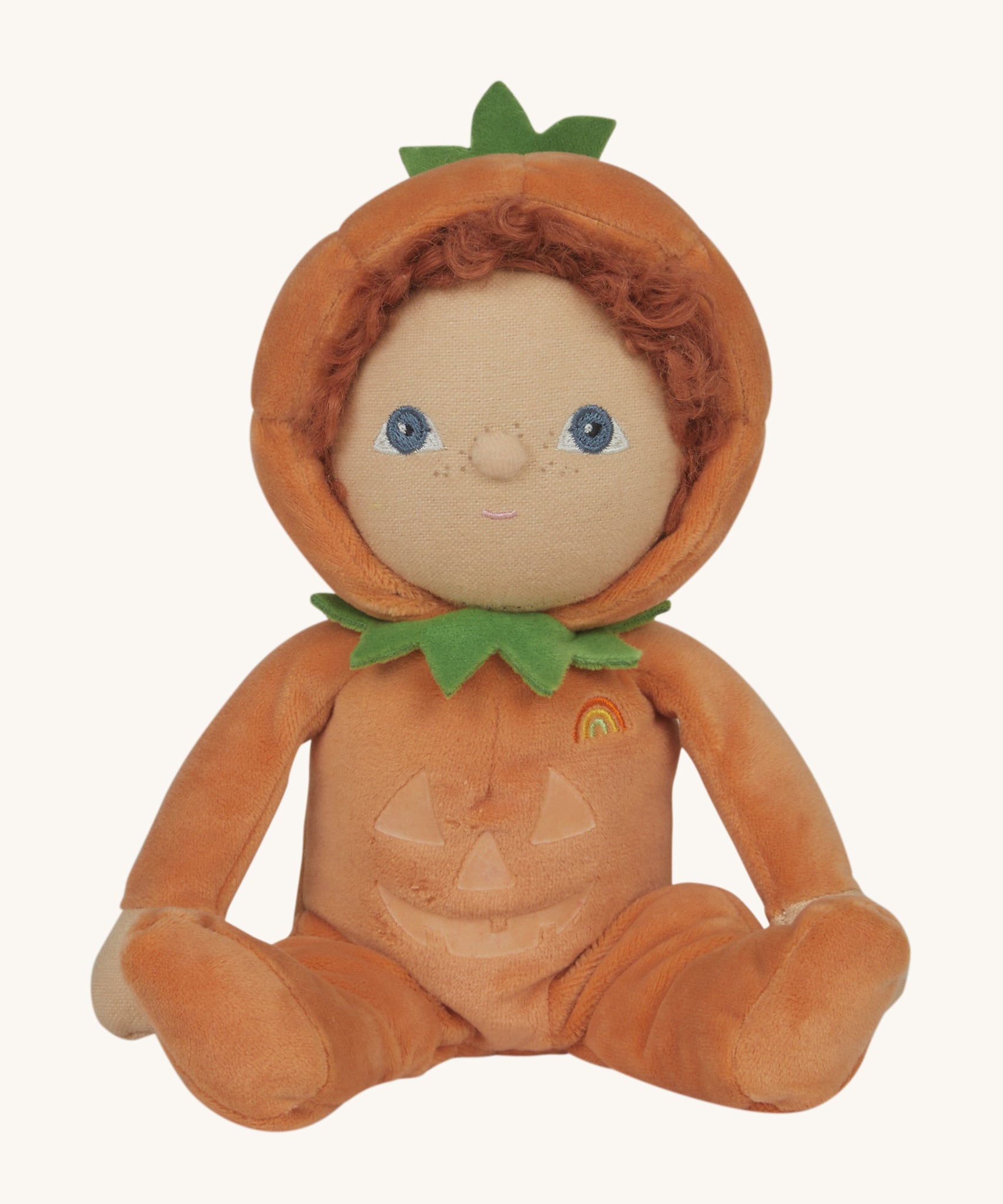 An Olli Ella Jack-O-Lantern pumpkin dinky dinkum doll. The soft doll has a glow in the dark face on it's belly and a small embroidered rainbow detail on it's chest. These soft toys are part of Olli Ella's Halloween collection available here at Babipur.