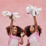 Two children playing with the unicorn toys from Olli Ella
