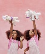 Two children playing with the unicorn toys from Olli Ella