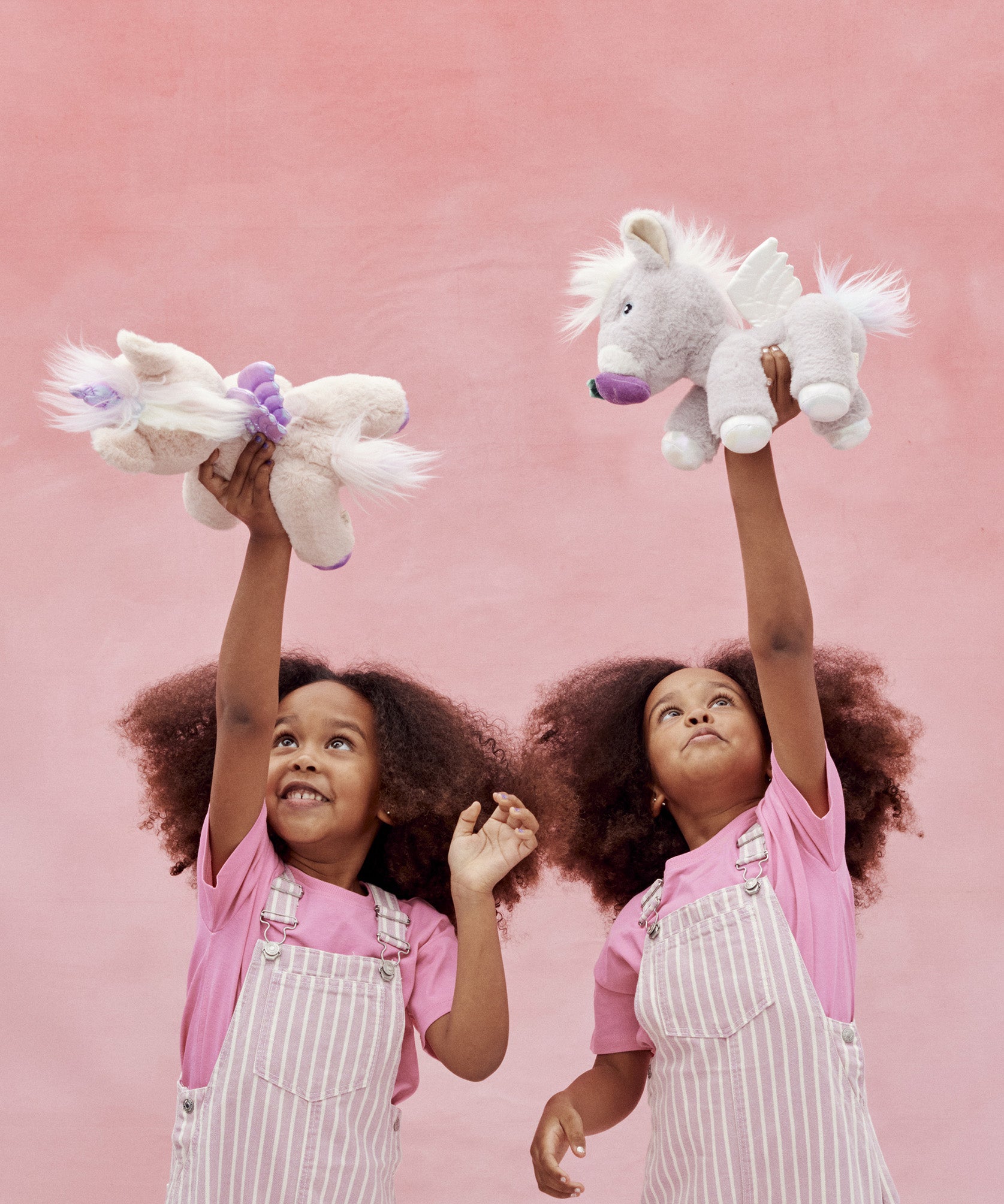 Two children playing with the unicorn toys from Olli Ella