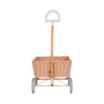 Front of the light pink Olli Ella rattan toy wagon on a white background