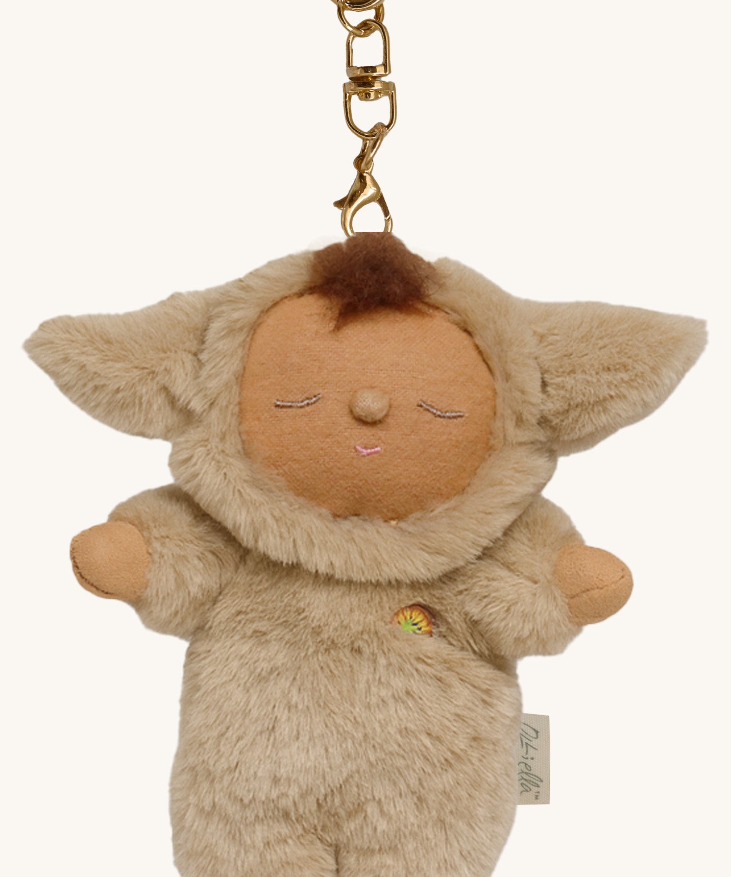 A close up of the Olli Ella lamby pip cozy bag charm available at Babipur showing cute ears and clip attached to charm for clipping on a backpack