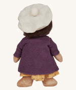 Olli Ella Dress Me Dinky - Lila Lavender wearing a purple fleece trench coat, yellow dress and white beret. Rear view, cream background. 