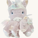 The dinkum unicorn is holding the baby unicorn with its magnetic mouth