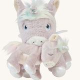 The dinkum unicorn is holding the baby unicorn with its magnetic mouth