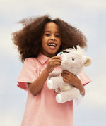 A child play feeding her unicorn toy
