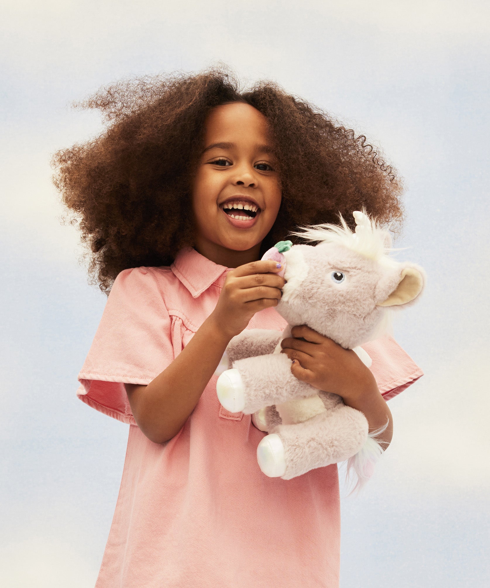 A child play feeding her unicorn toy