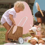 surrounded by Cosy Dinkum dolls and colourful toy eggs