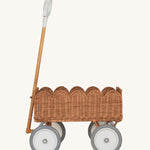 A side profile of the Olli Ella Natural Rattan Petal Wonder Wagon.