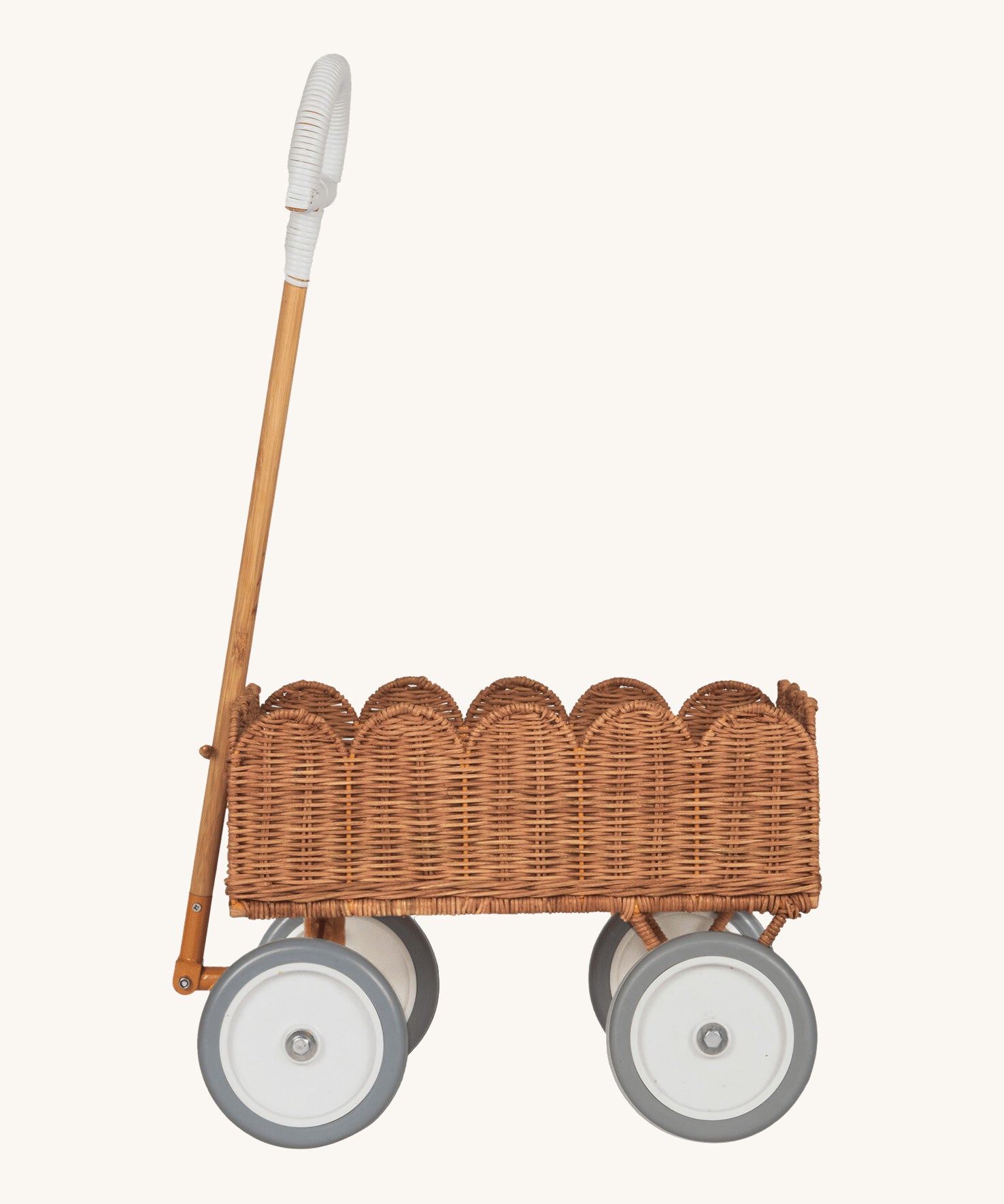 A side profile of the Olli Ella Natural Rattan Petal Wonder Wagon.