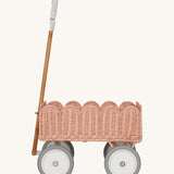A side profile of the Olli Ella Seashell Pink Rattan Petal Wonder Wagon.