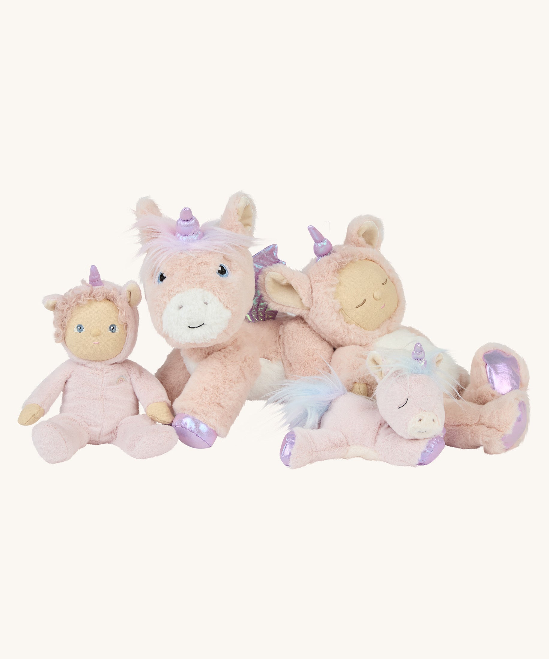 The Olli Ella pink unicorn collection posed together; a dinkum doll, a dinky doll, a dinkum unicorn, and a baby unicorn