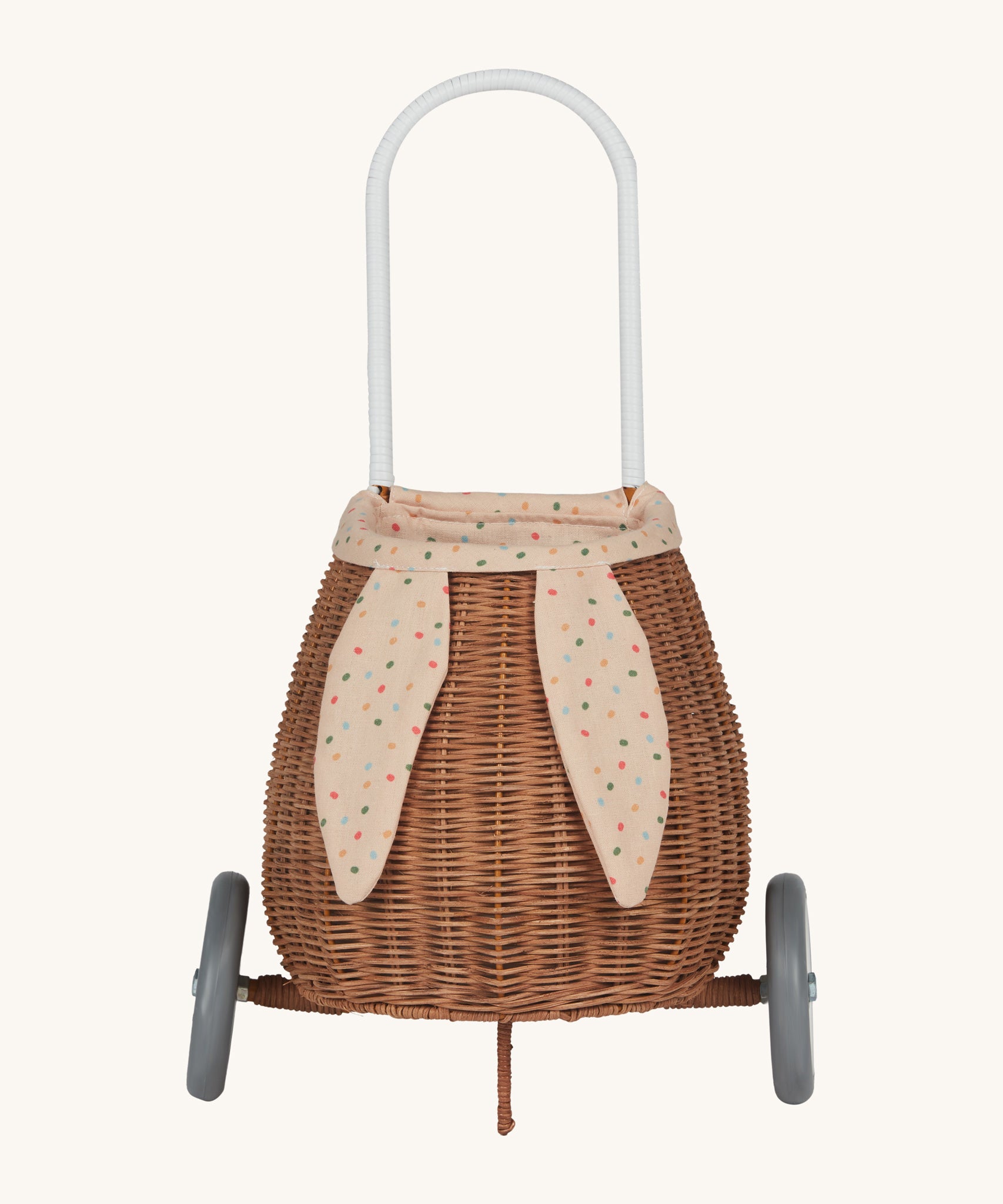 Olli Ella Rattan Bunny Luggy with Lining – Gumdrop. A beautifully woven Luggy roll along basket with a light peach lining and gum drop detail.