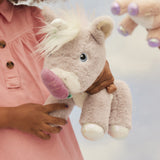 A child holding and feeding the toy unicorn