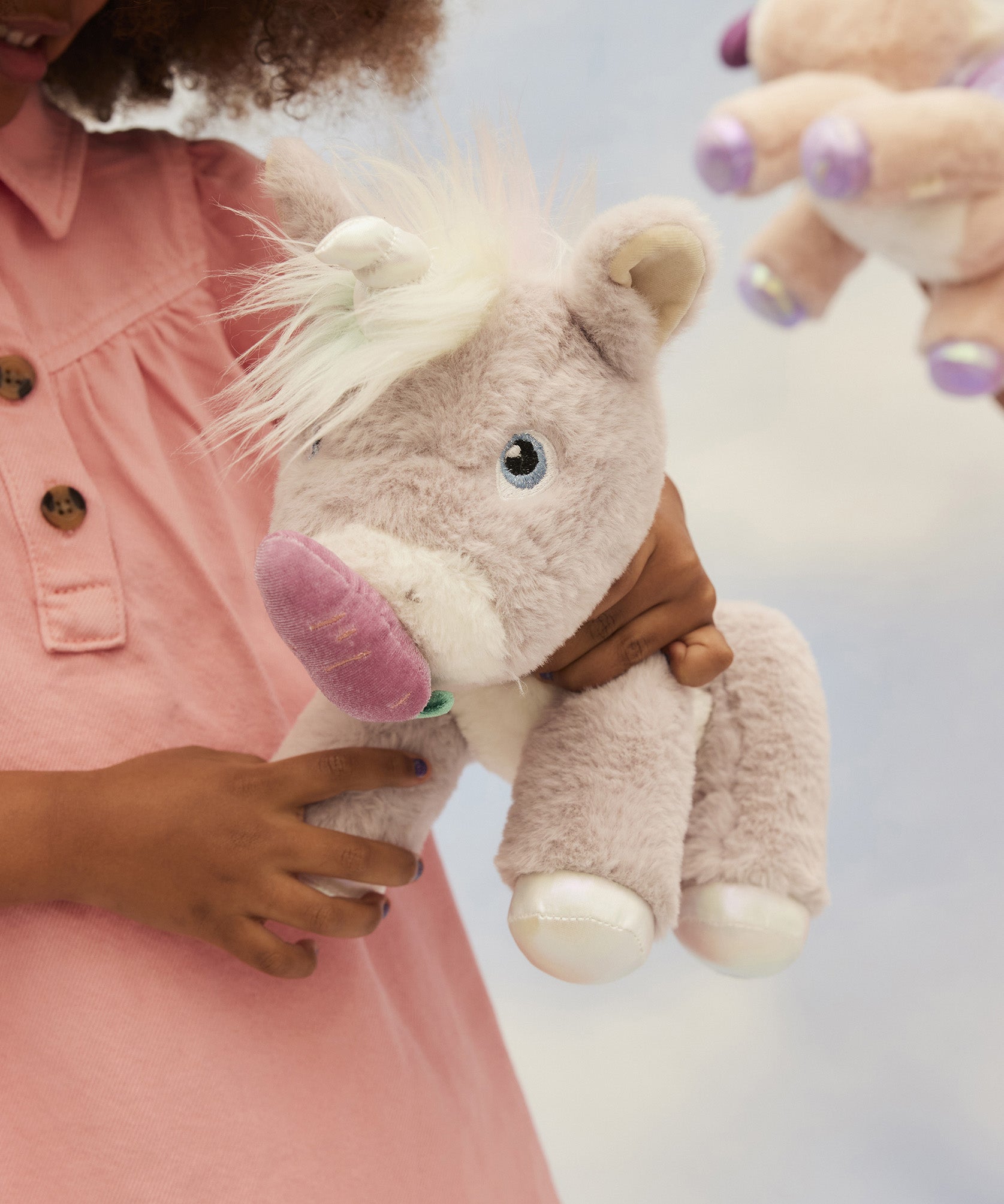 A child holding and feeding the toy unicorn