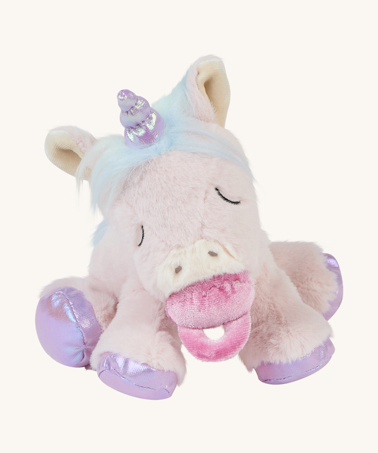 The baby unicorn toy sat down with a dummy