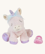 Olli Ella baby unicorn positioned to sit down, with its pink dummy beside it