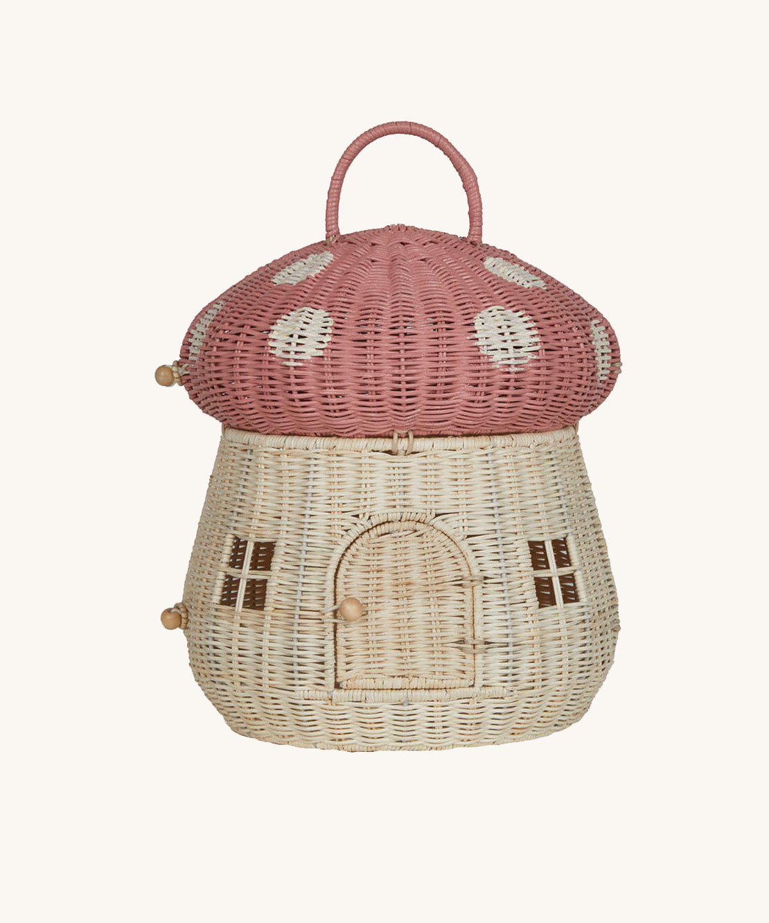The Olli Ella Rattan Woven mushroom doll's house, with a pink spotty toadstool top and an opening door. 