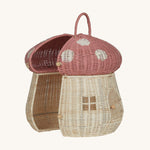 The Olli Ella Rattan Woven mushroom doll's house, with a pink spotty toadstool top, half opened.