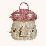 The Olli Ella Rattan Woven mushroom doll's house, with a pink spotty toadstool top and an opening door.