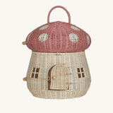 The Olli Ella Rattan Woven mushroom doll's house, with a pink spotty toadstool top and an opening door.