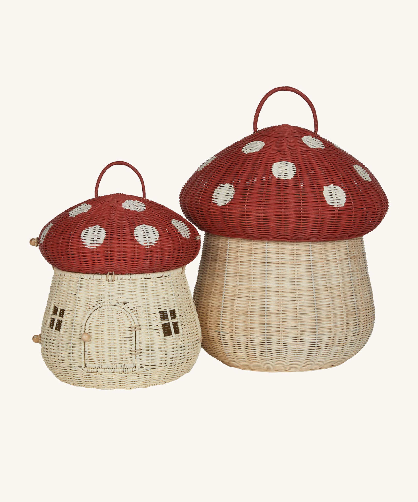 The Olli Ella Rattan Woven mushroom doll's house, with a red spotty toadstool top, next to the large toadstool woven basket in the same colour.