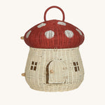 The Olli Ella Rattan Woven mushroom doll's house, with a red spotty toadstool top and an opening door.