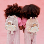 2 kids with the lilac and pink olli ella fluffy backpacks on their backs with the dinky dinkum dolls sitting inside