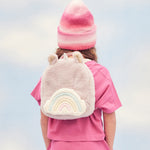 A child wearing the pink fluffy Olli Ella backpack.