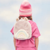 A child wearing the pink fluffy Olli Ella backpack.