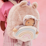 A close up of the pink fluffy backpack with a dinky dinkum doll sitting inside the bag