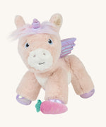 The Olli Ella Shimmer unicorn, which has light pink fur and a lilac mane, with a pink carrot at its feet